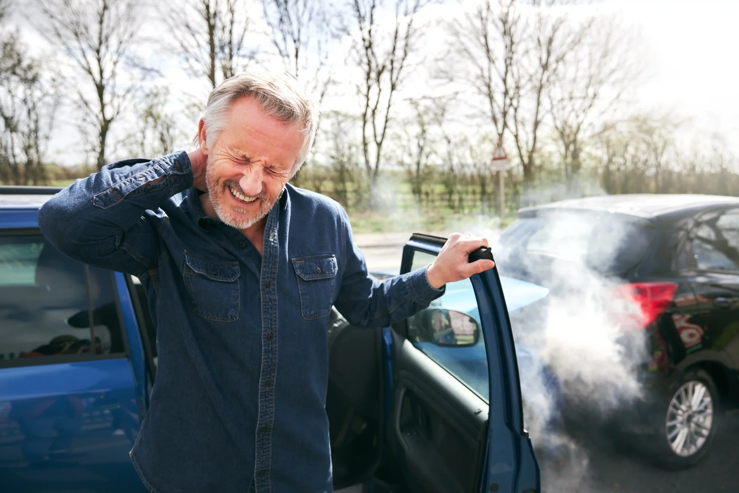 man feeling pain in his neck from an auto accident. needs chiropractic treatment.