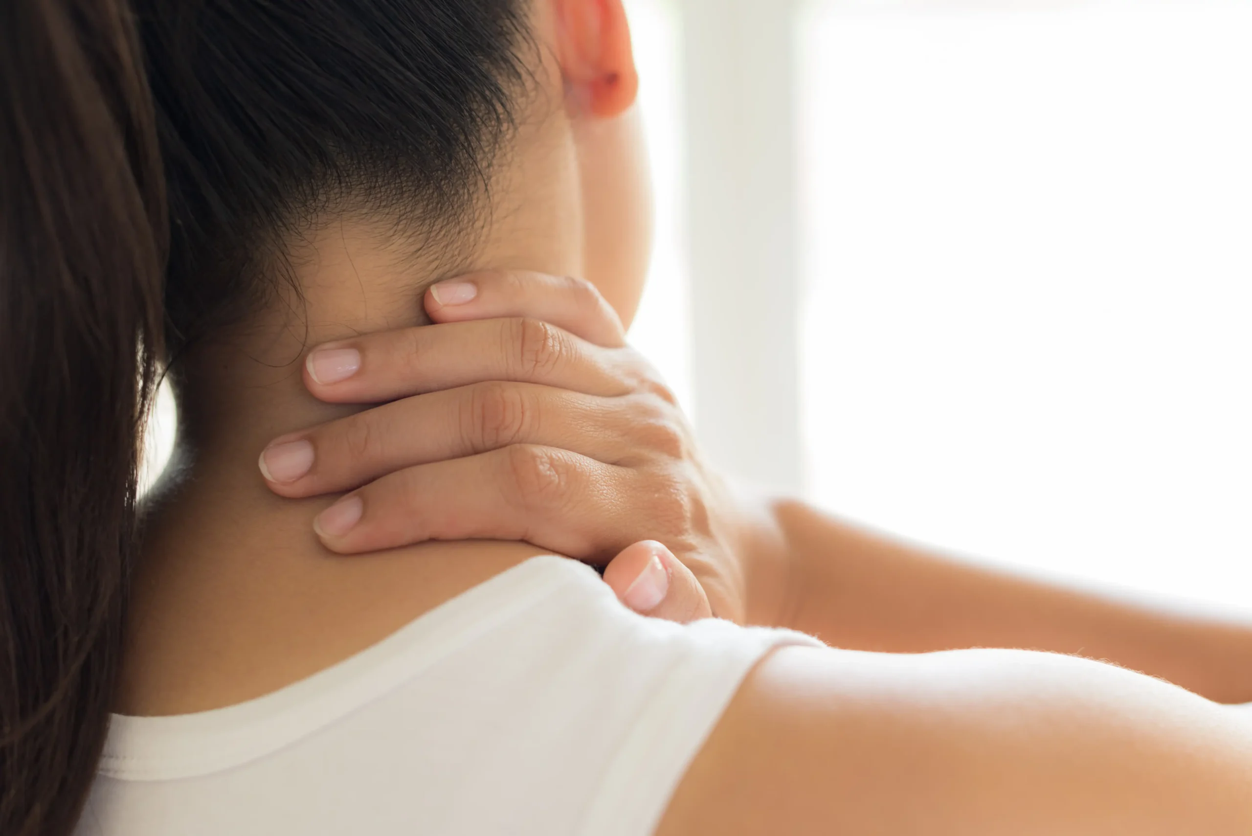 patient experiencing neck pain; in need of a chiropractic adjustment