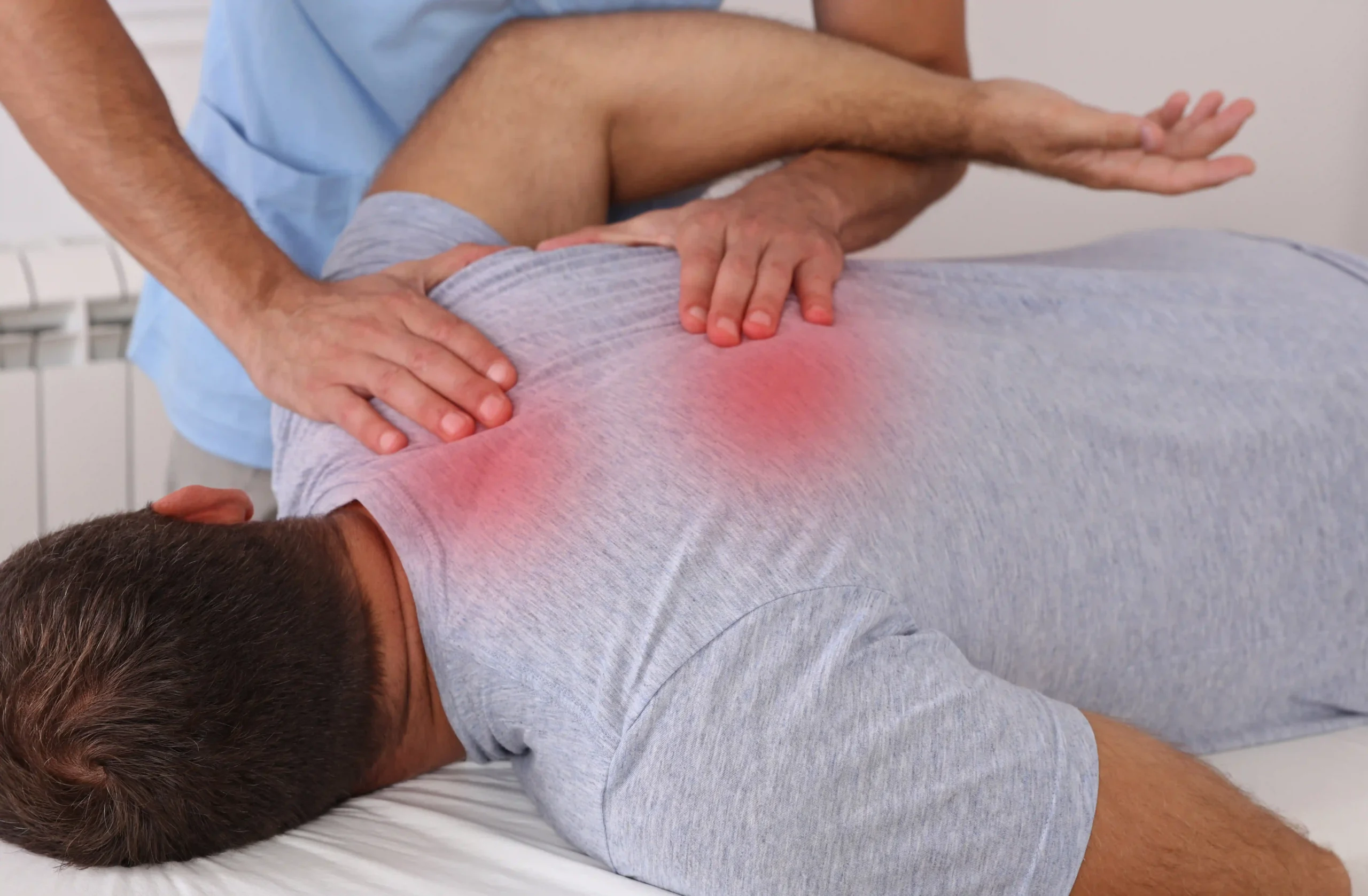 Chiropractor in Chapin, SC applying trigger point therapy on a patient.